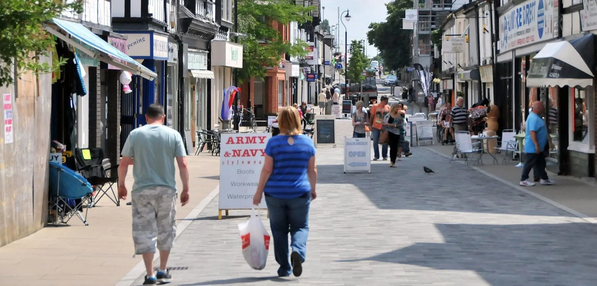 photo of people walking down highstreet in england