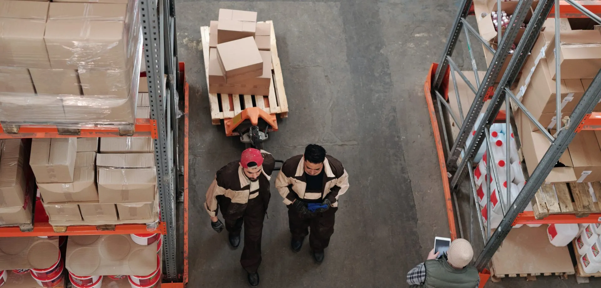 aerial photo of 2 men working in a warehouse