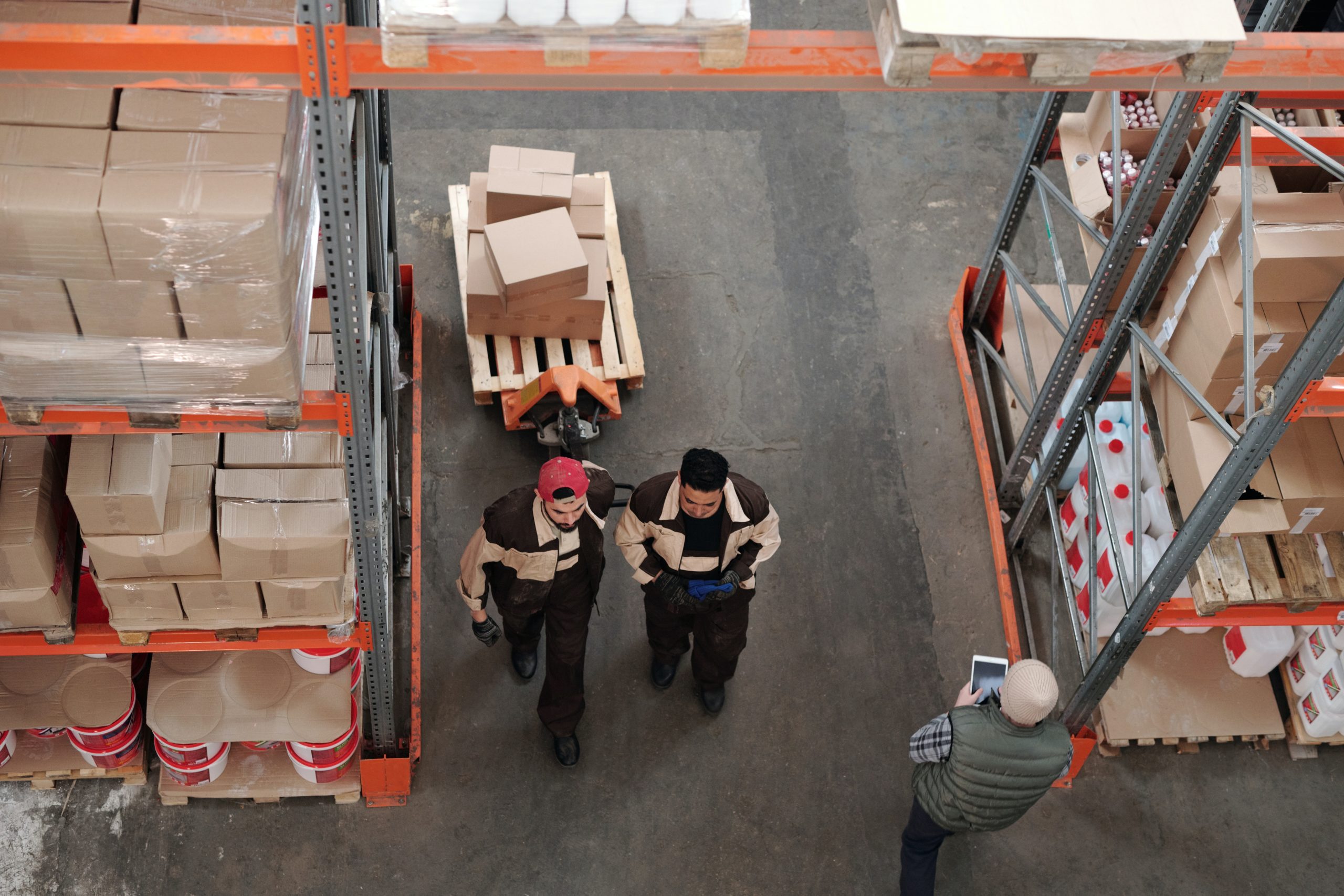 aerial photo of 2 men working in a warehouse